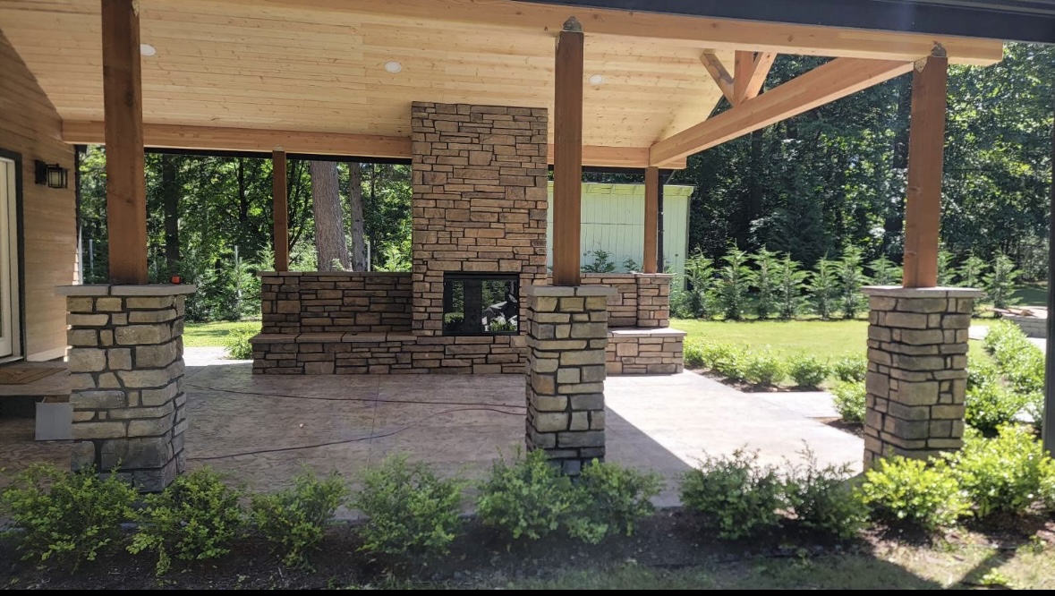 Outdoor stone veneer fireplace and patio