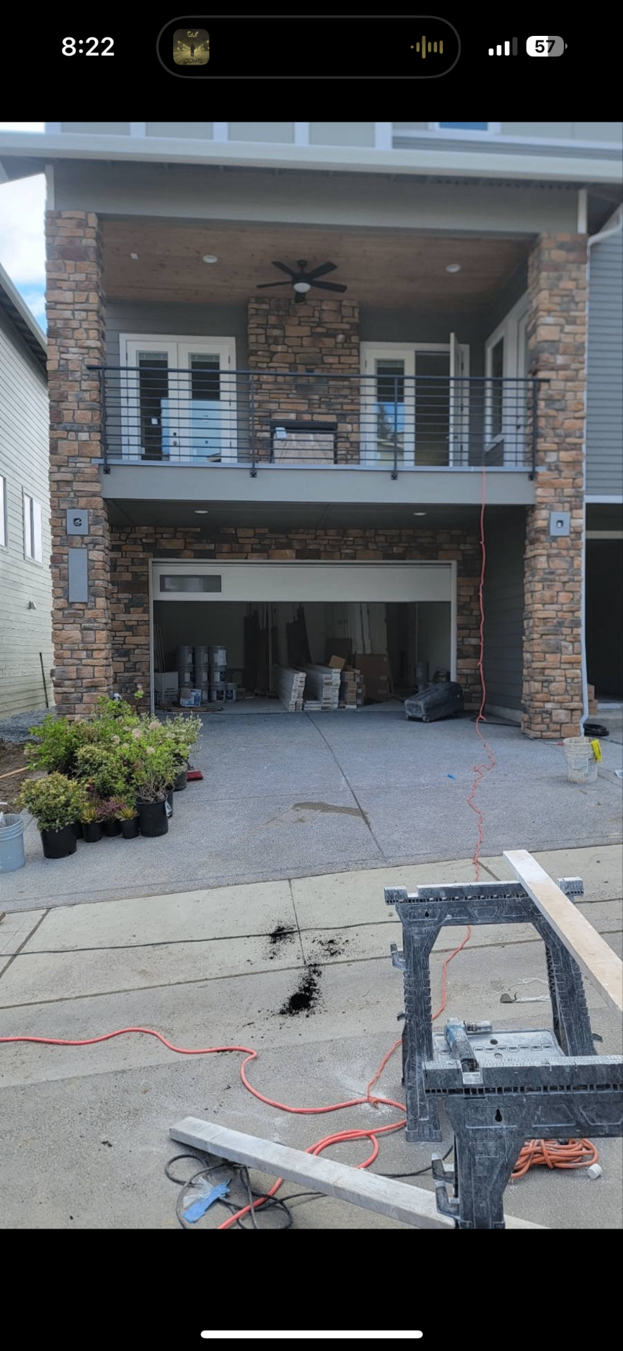 Exterior stone veneer columns wrapping a covered balcony