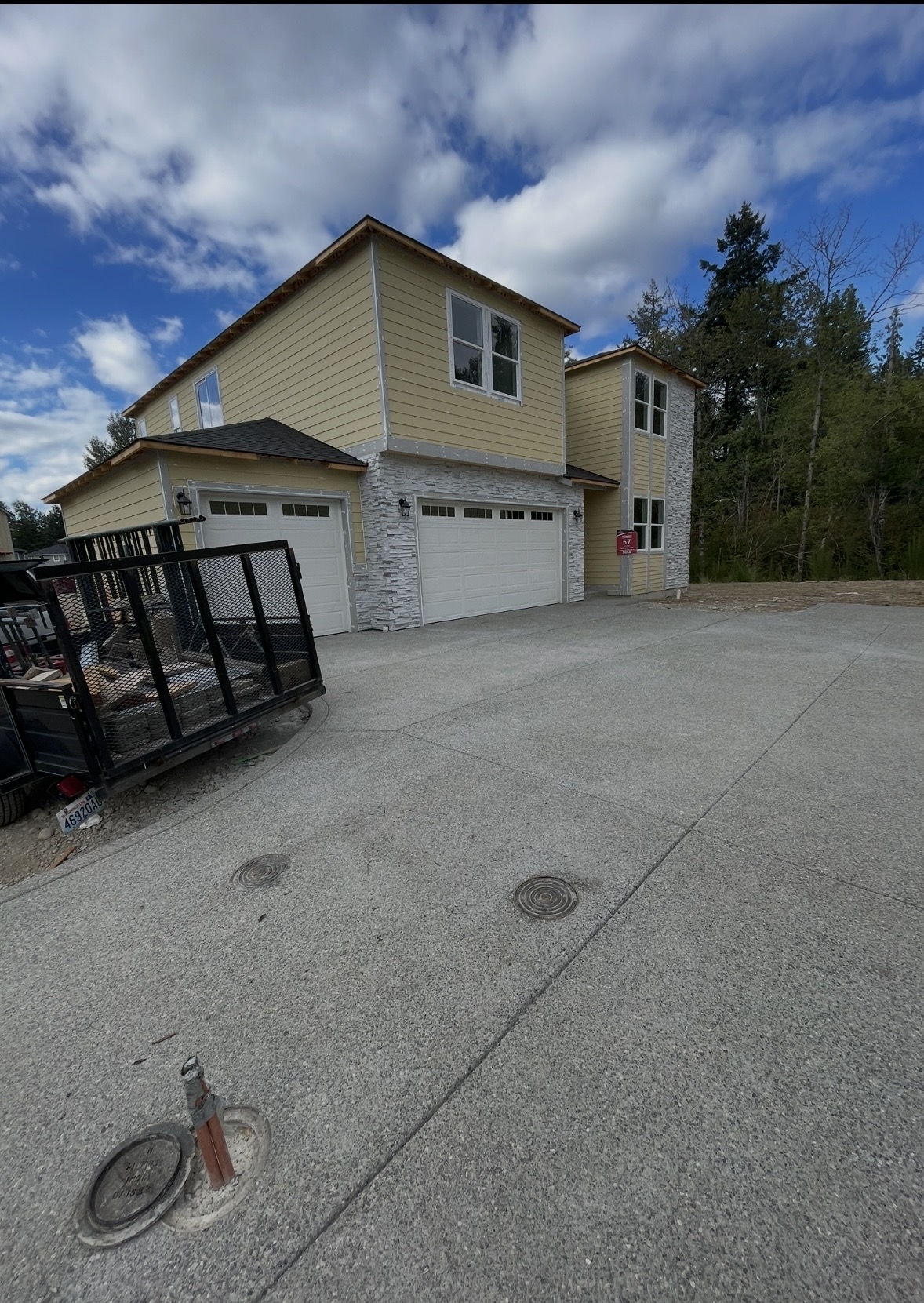 Two-story home with white stone veneer wainscot
